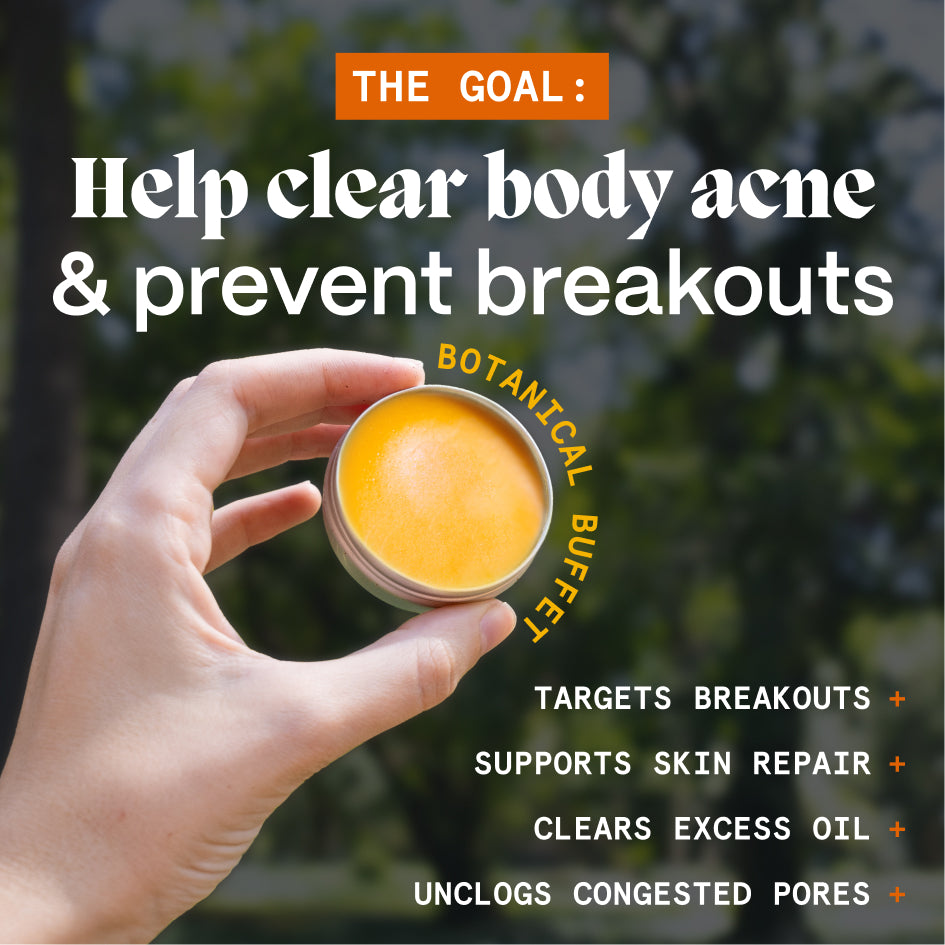 Hand holding an open tin of the body acne balm outdoors with a goal graphic about clearer-looking skin